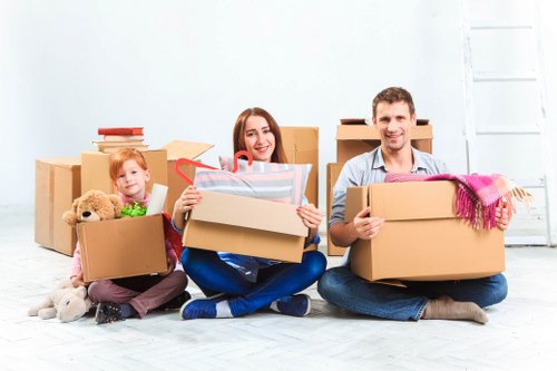 Removal team preparing a Kingsbury flat move with boxes and furniture