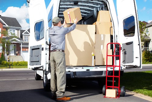 Team member wearing PPE while handling boxes during transport